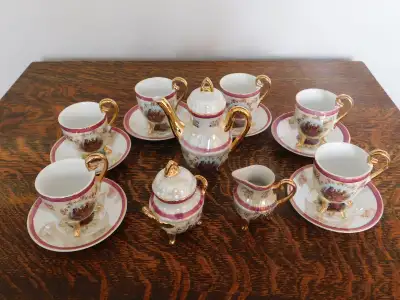Thirteen-piece doll coffee set. Six plates, six cups, coffee pot with lid, sugar with lid, and cream...