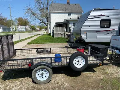 This is long single axle trailer that was camper in a previous life. New rims and tires, wiring redo...