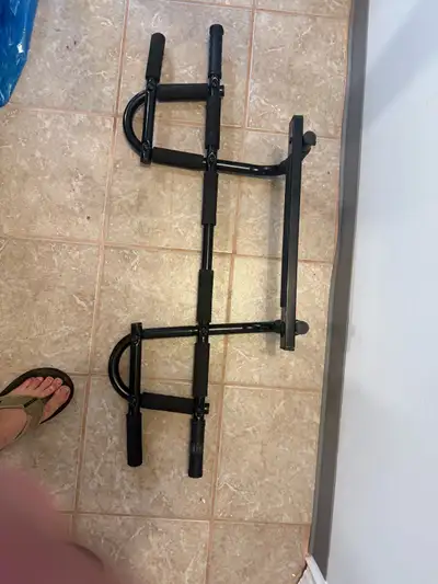 This is a used doorway pull-up bar that is great for getting in a quick workout at home. It is in go...