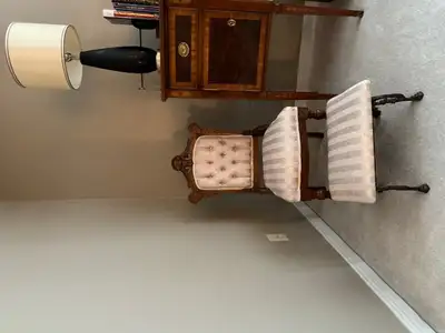 Antique Queen Anne chair and matching footstool. Carved wood edging detail. It has been re-upholster...