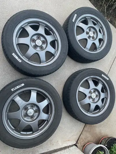 16-inch Toyota wheels wrapped in Toyo Extensa II A/S all-season tires, sized 195/55R16. Tires are in...