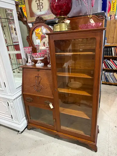 Beautiful vintage oak secretary cabinet. Drop front with a bottom display case and a large cabinet t...