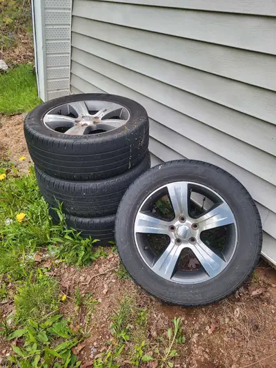 I'm selling a set of four used rims with tires, perfect for giving your vehicle a stylish upgrade. T...