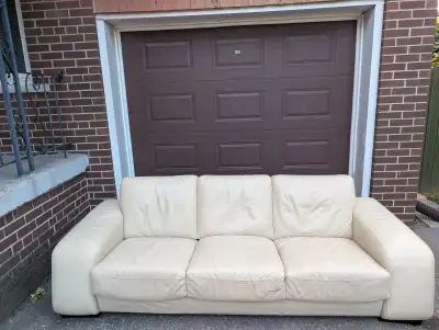 Beautiful cream genuine leather 3-seater sofa. Modern, low-profile design with wide arms and deep se...