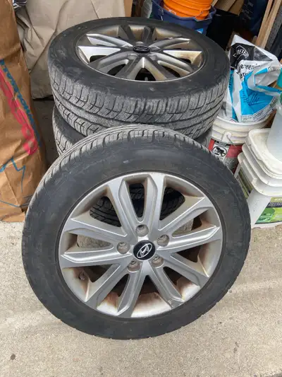 4 rims with tires still on originals from a 2015 Hyundai Elantra Tires themselves are pretty much do...