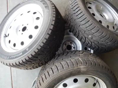 Set of 4 winter tires on silver rims 225/55R17 101T wheel size 17X7 bolt pattern 5-100 center bore 5...