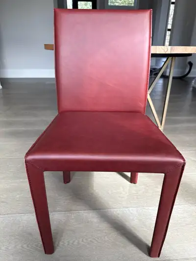 This Crate and Barrel Folio side chair features a sleek, modern design with its striking Merlot leat...