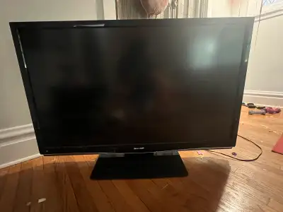 This is a used 52 inch Sharp LCD TV, model LC-52D64U, perfect for a cozy living room or entertainmen...