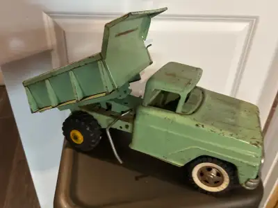 This vintage Tonka dump truck is a classic piece of metal craftsmanship, perfect for collectors or a...
