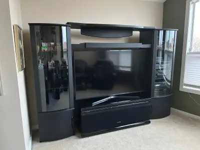 Old school entertainment centre, 2 towers( with shelves,lights) and upper horizontals. Electronics a...