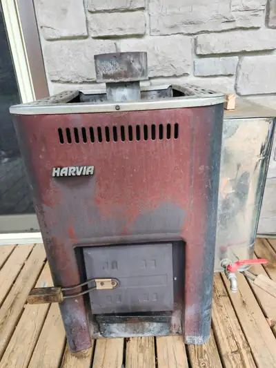 Harvia wood fired sauna stove with side mounted water heater.
