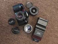 Minolta slr film camera with 3 lenses and flash 