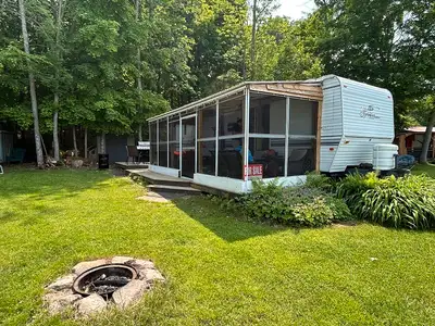 This is a large trailer with lots of living space. The main bedroom has a queen size bed in the rear...