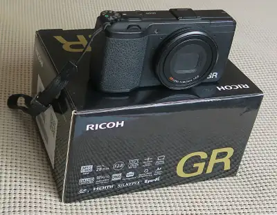 It comes in box with original accesories (cd software, charger with USB cable, battery, strap) plus...