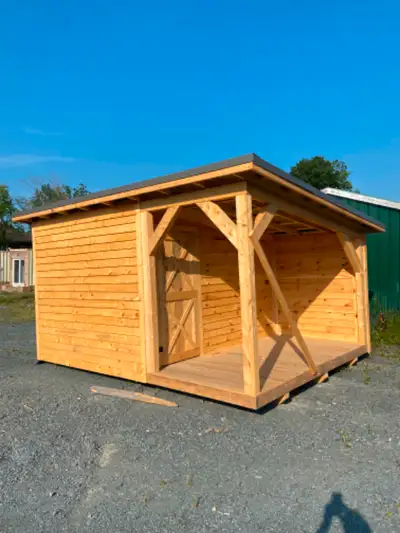 16ft by 12 ft shed with a porch. All built out of rough cut lumber with a metal roof .