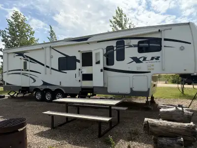 I'm selling a used XLR by Forest River toy hauler, a versatile RV perfect for adventurers! This fift...