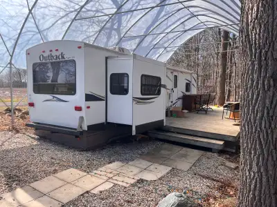 2011 Keystone outback travel trailer with rear living area, including pop-up LCD TV with overhead ca...