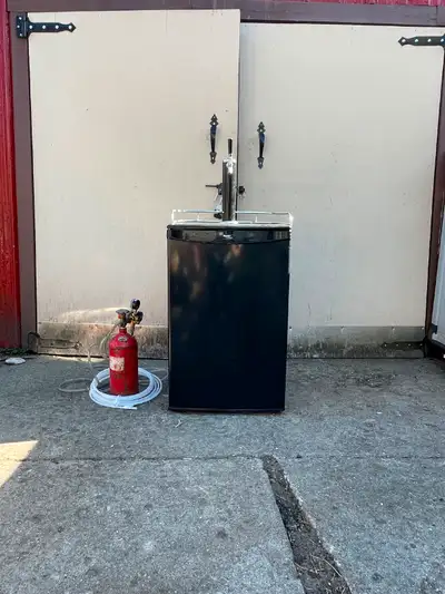 Keg fridge and co2 tank. All in working condition. Tap mounted to top .