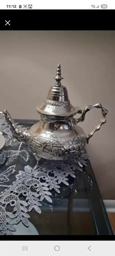 Royal Stamped Decorative Tea Pot – Collectible Piece Elegant vintage-style metal tea pot featuring a...