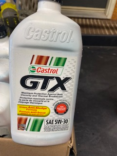 case of 12 bottles of Castrol GTX 5W-30 motor oil. Some bottles have slight discoloration due to sto...