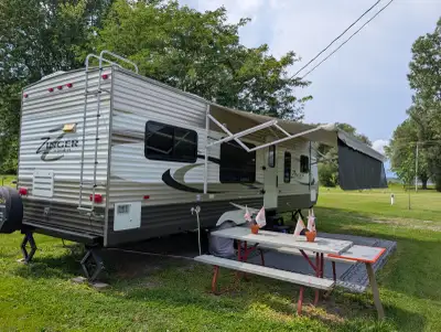 Well-kept 2014 CrossRoads Zinger 300RK travel trailer for sale, currently set up on a seasonal camps...