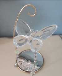 Sparkling faceted acrylic butterfly on mirrored stand