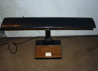 Vintage 70's desk or table lamp, working. Has faux wood grain base and piano key switches. Shade 18"...