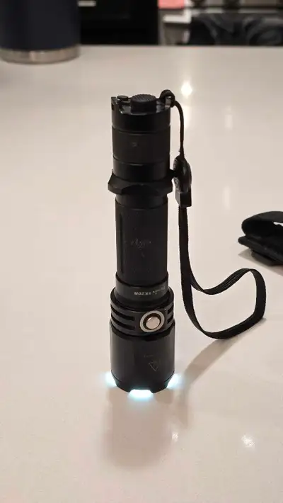 1000 lumens. Great throw. Tight beam. Rechargeable. Nylon holder is unused. Great shape and works fl...
