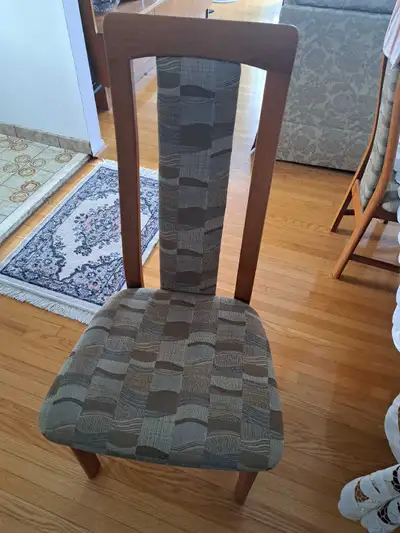 This is a used teak wood chair, perfect for adding a touch of mid-century modern style to your dinin...