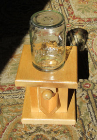 Wood and mason jar nut dispenser.