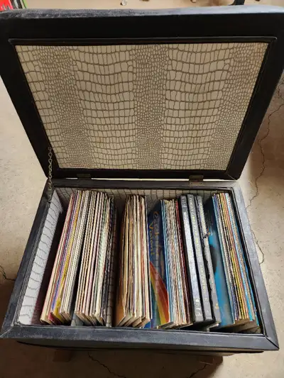 Leather Ottoman full of Vinyl Records 33 RPM. Over 70 vinyl records of various music; some box sets....