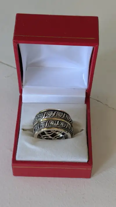 9 karat gold spinner ring is crafted from  sterling silver., View more
