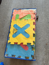 Kid playing letter mat