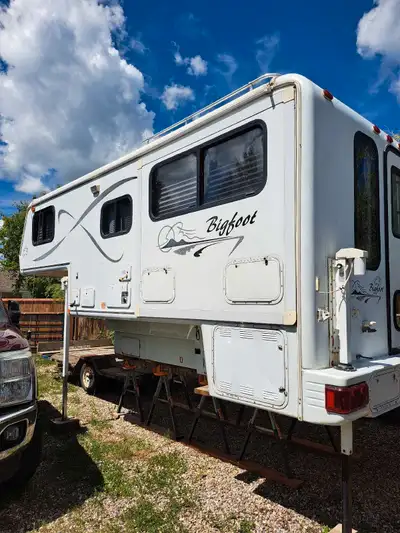 Check out this used Bigfoot Truck Camper, ready for your next adventure! It features a cozy interior...