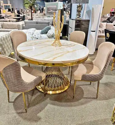This used round dining table comfortably seats four and features a stunning faux marble top with a g...