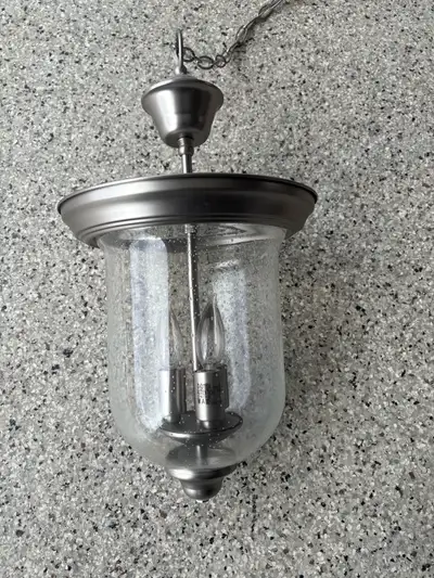 Add a touch of elegance to your home with this brushed nickel hanging light, measuring 10 inches lon...