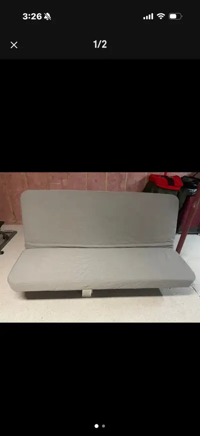 This is an IKEA light gray futon convertible couch/bed, perfect for small spaces or as an extra slee...