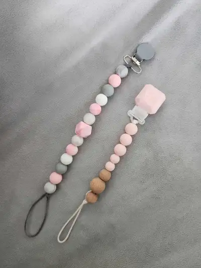 One Loulou Lollipop Pacifier clip and one crafted Pacifier clip with silicone beads. Both never used...