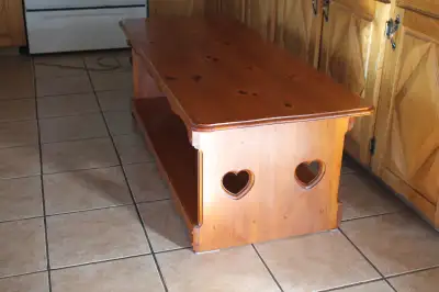 REDUCED $50 ...For sale Solid Pine coffee Table , With 2 router Hearts on both ends Front Face scall...