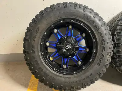 Set of 4 Size LT275/70R18 Mounted on RTX offroad wheels. Rims are black with blue spokes Bolt patter...