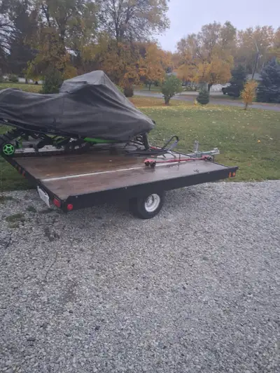 Tilt snowmobile trailer. 8.5 feet wide asking $1200 or best offer