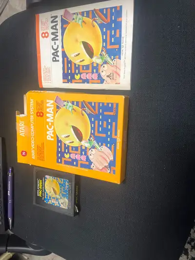 Relive the arcade excitement with this vintage Atari Pac-Man game cartridge, a classic piece of gami...