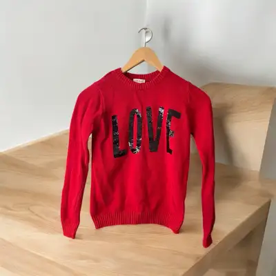 Like new girl's Joe Fresh red sweater with black LOVE printed in sequins. This is the perfect long s...