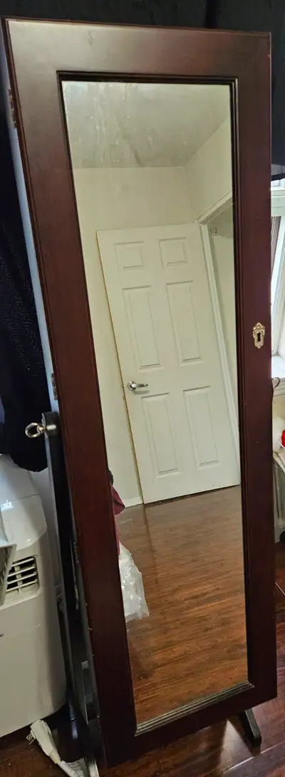 Standing mirror that opens so you can store your jewelry etc. I no longer have the key but the door...