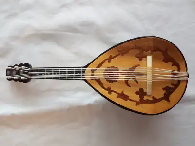 a nice little musical instrument with winding on the side playing music. it is a nice little piece f...