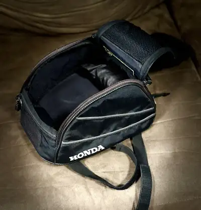 Item 1, small Honda brand tail bag with integrated rain cover, velcro straps, two inside pockets, no...