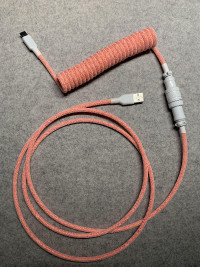 orange + white coloured coiled keyboard cable