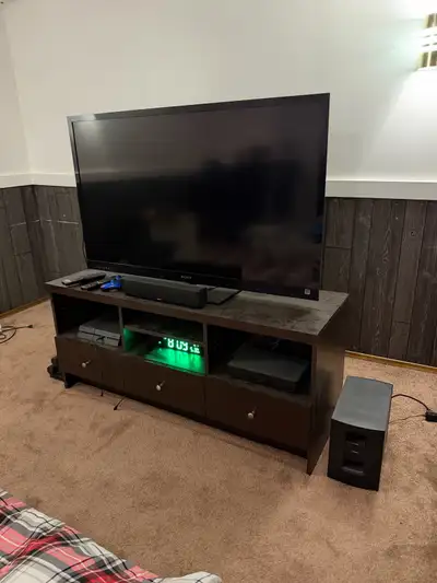 Black Sony Bravia 55 ” flat-screen television has a slim bezel and a rectangular stand. This electro...