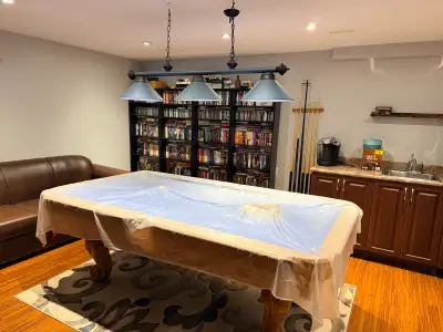 Elevate your game room with this ornate wooden slate-base pool table featuring vibrant blue felt tha...