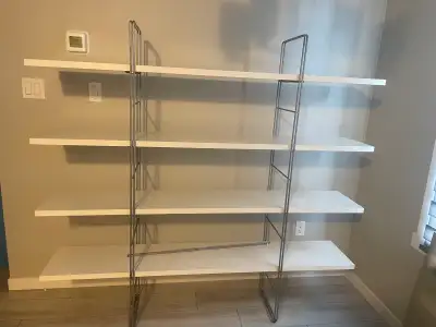 Elevate your space with this stylish and functional white and silver IKEA shelving unit, featuring f...